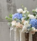 Basket with peonies, roses and astilba