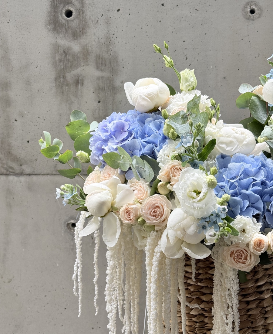 Basket with peonies, roses and astilba