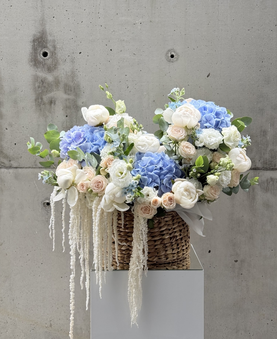 Basket with peonies, roses and astilba