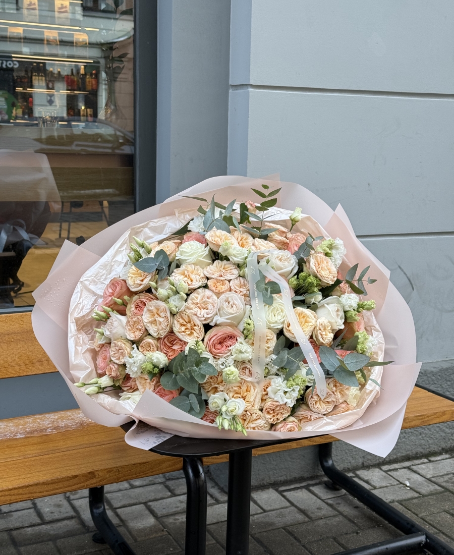 Bouquet with peony roses, roses, lisianthus (eustoma) combined with fragrant eucalyptus